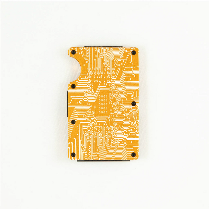 RFID-shielding orange aluminum wallet with engraved circuit board design.