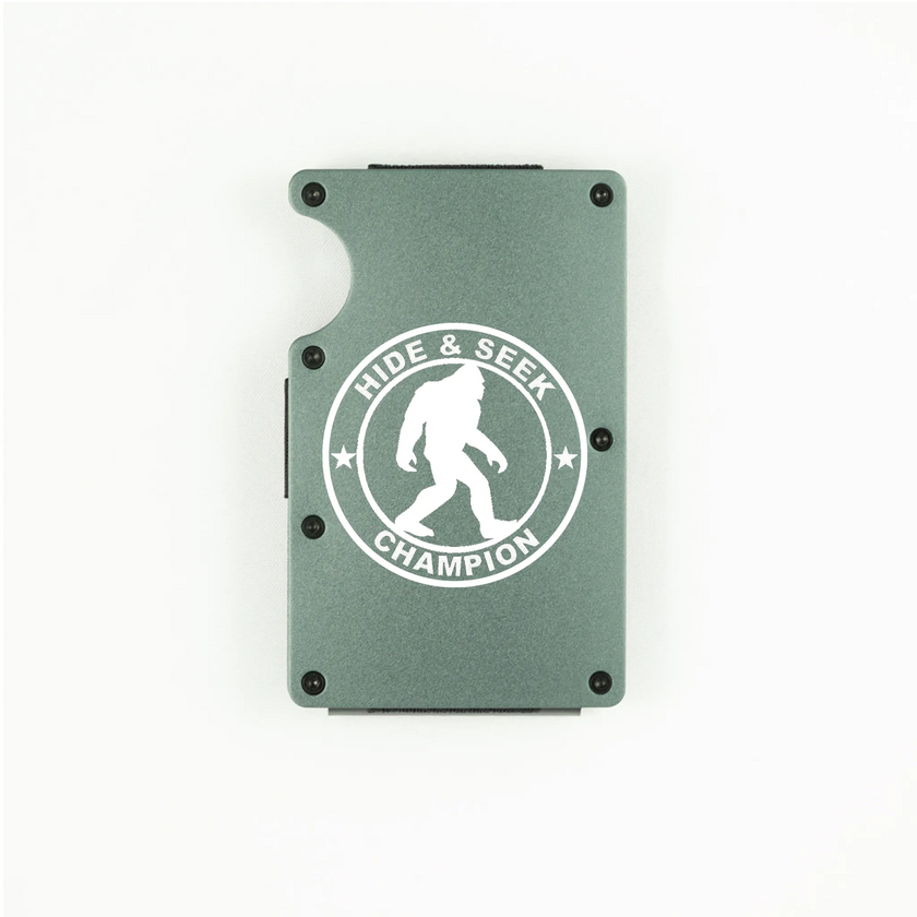 Dark grey aluminum RFID wallet with engraved Hide and Seek Champion Bigfoot badge