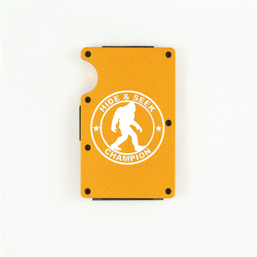 Orange aluminum RFID wallet with engraved Hide and Seek Champion Bigfoot badge