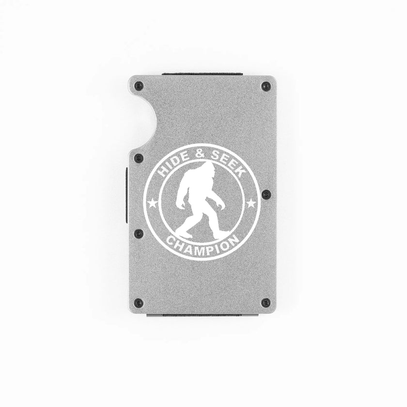 Silver aluminum RFID wallet with engraved Hide and Seek Champion Bigfoot badge