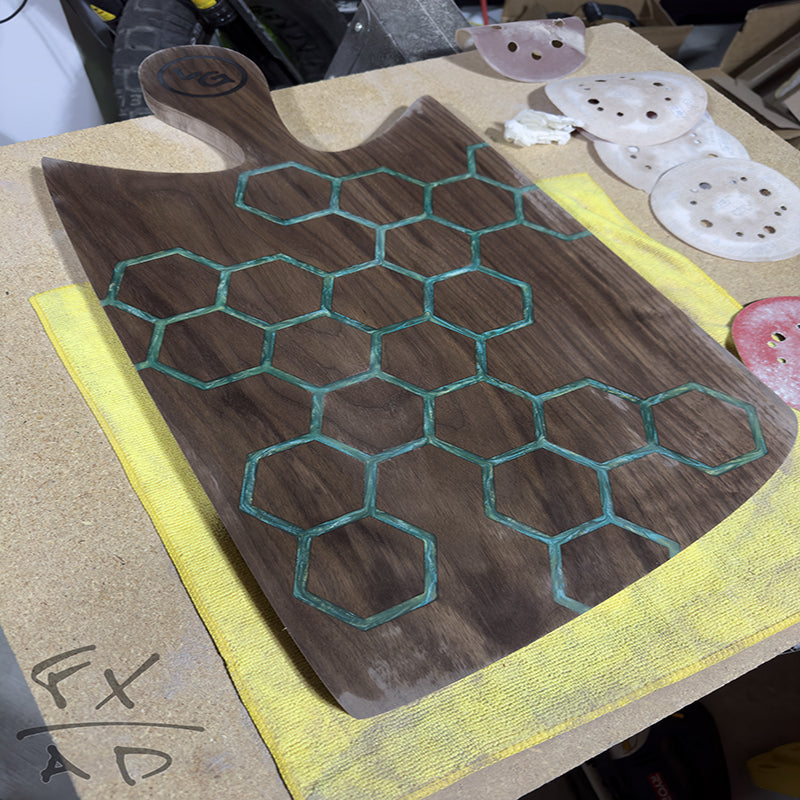 Walnut charcuterie board with hexagon pattern and green epoxy fill - Elegant and unique, perfect for serving and entertaining.