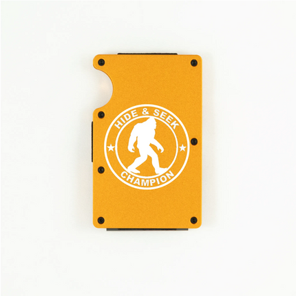 Orange aluminum RFID wallet with engraved Hide and Seek Champion Bigfoot badge