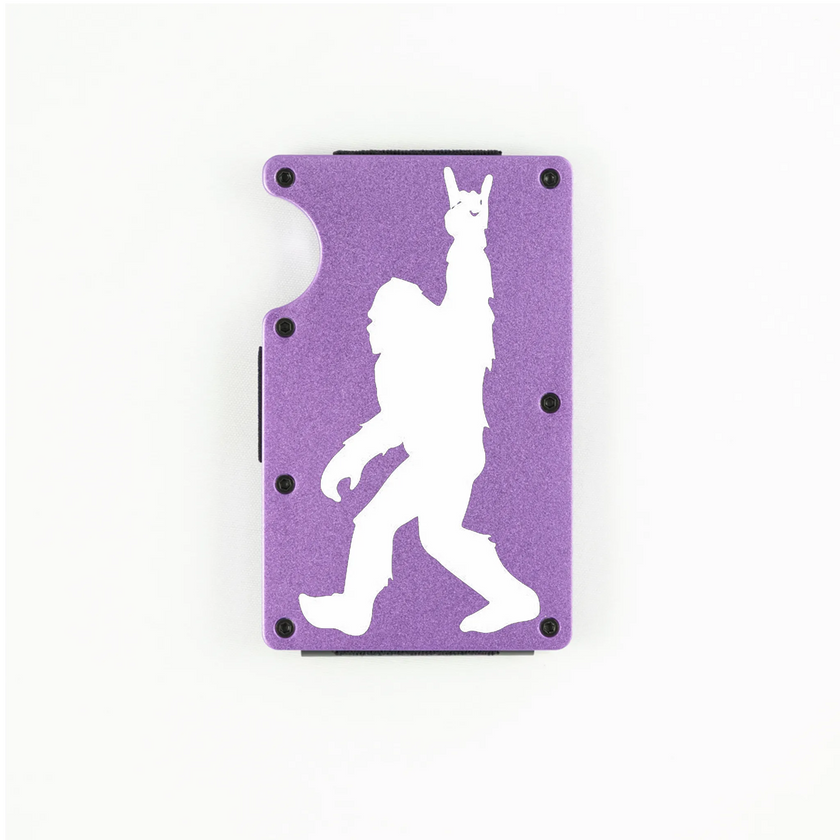 Purple aluminum RFID wallet with engraved Bigfoot doing rock on hand gesture