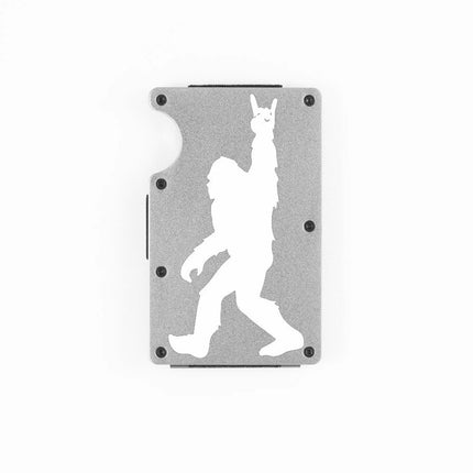Silver aluminum RFID wallet with engraved Bigfoot doing rock on hand gesture