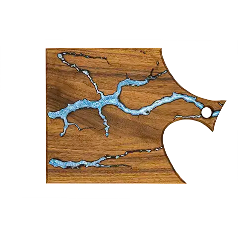 Walnut charcuterie board with an integrated handle, featuring a light-blue fractal burn pattern inlaid with food-safe epoxy.